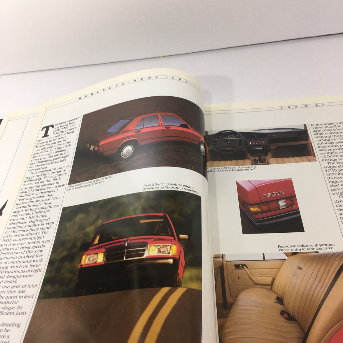 Interior and exterior images from the 1984 Mercedes-Benz 190E 2.3/190D 2.2 Sedans Dealership Car Auto Brochure Catalog showcasing detailed features.