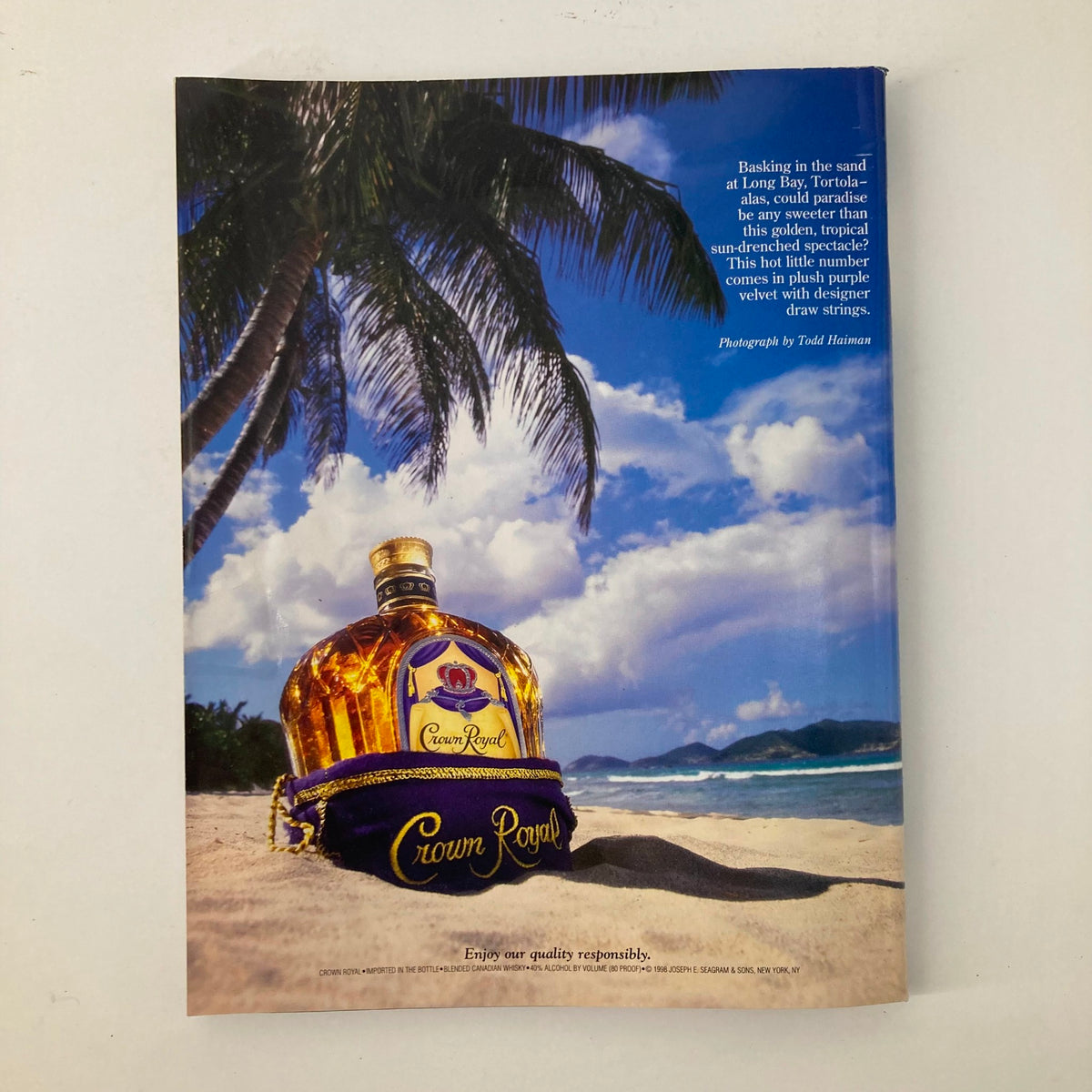 Advertisement page for Crown Royal whiskey in Sports Illustrated Magazine Winter 1999, showcasing a bottle on a tropical beach with palm trees.