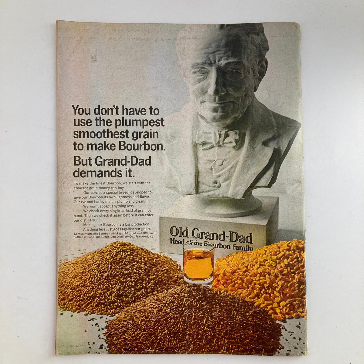 Advertisement page from the vintage Newsweek magazine dated March 11, 1968, featuring a promotion for Old Grand-Dad bourbon, showcasing the product with grains and a statue.