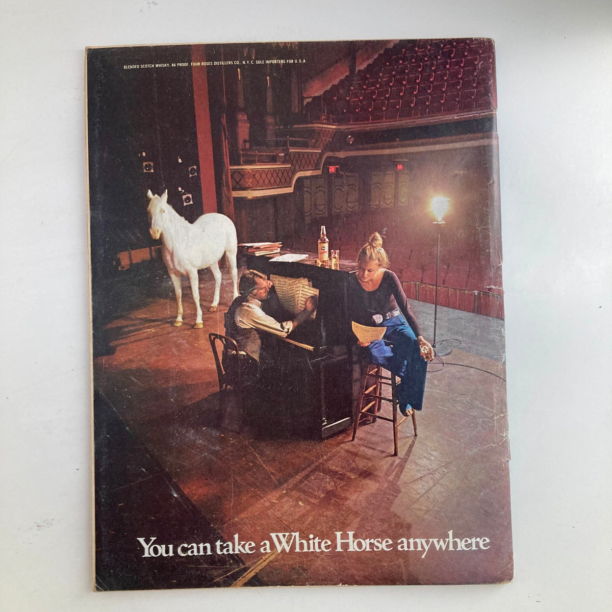 Back cover of the VTG Newsweek Magazine dated October 8, 1973, featuring an artistic photo with a white horse and a woman at a piano, accompanied by the phrase "You can take a White Horse anywhere."