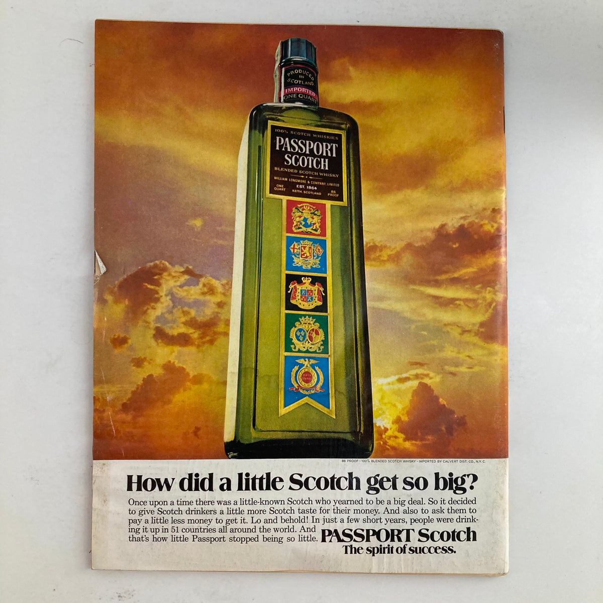 Vintage passport Scotch advertisement from July 16, 1973, featuring a large bottle against a dramatic sunset background. The ad poses the question, 'How did a little Scotch get so big?' showcasing the product's appeal and marketing message related to its success.