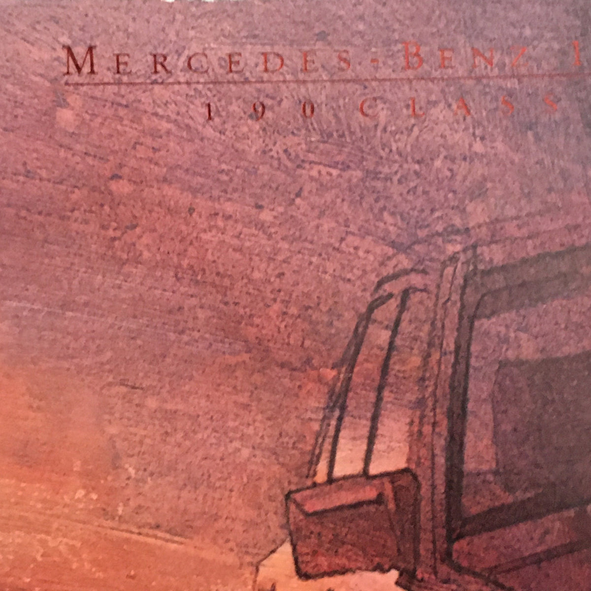 Close-up detail of the 1985 Mercedes-Benz 190-Class Dealership Car Auto Brochure Catalog, showcasing the model name in an artistic design.