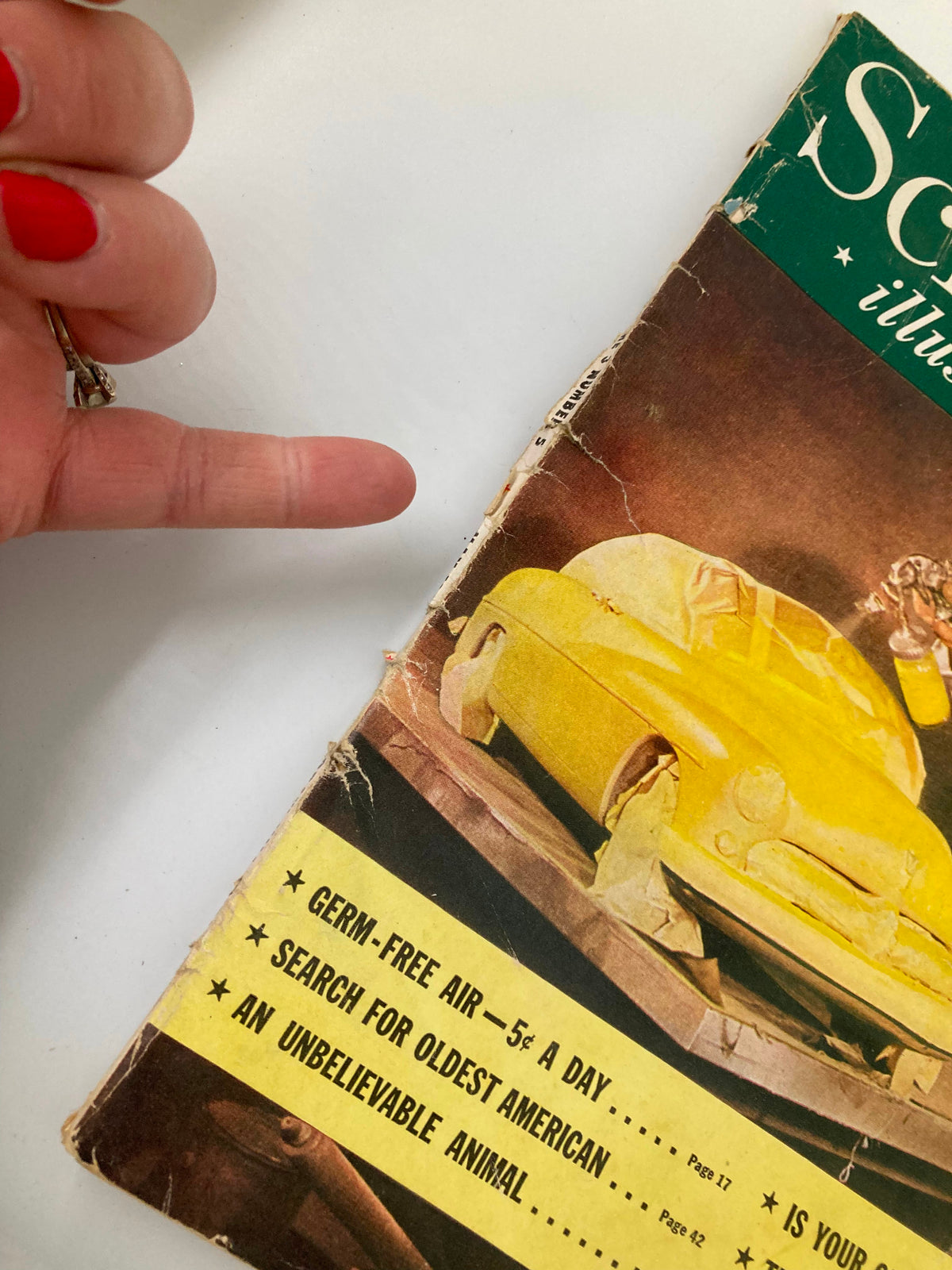 Close-up view of the cover of VTG Science Illustrated Magazine May 1948, displaying Detroit's Newest Car Picture Report with a man working on a yellow car and hand pointing to featured articles.