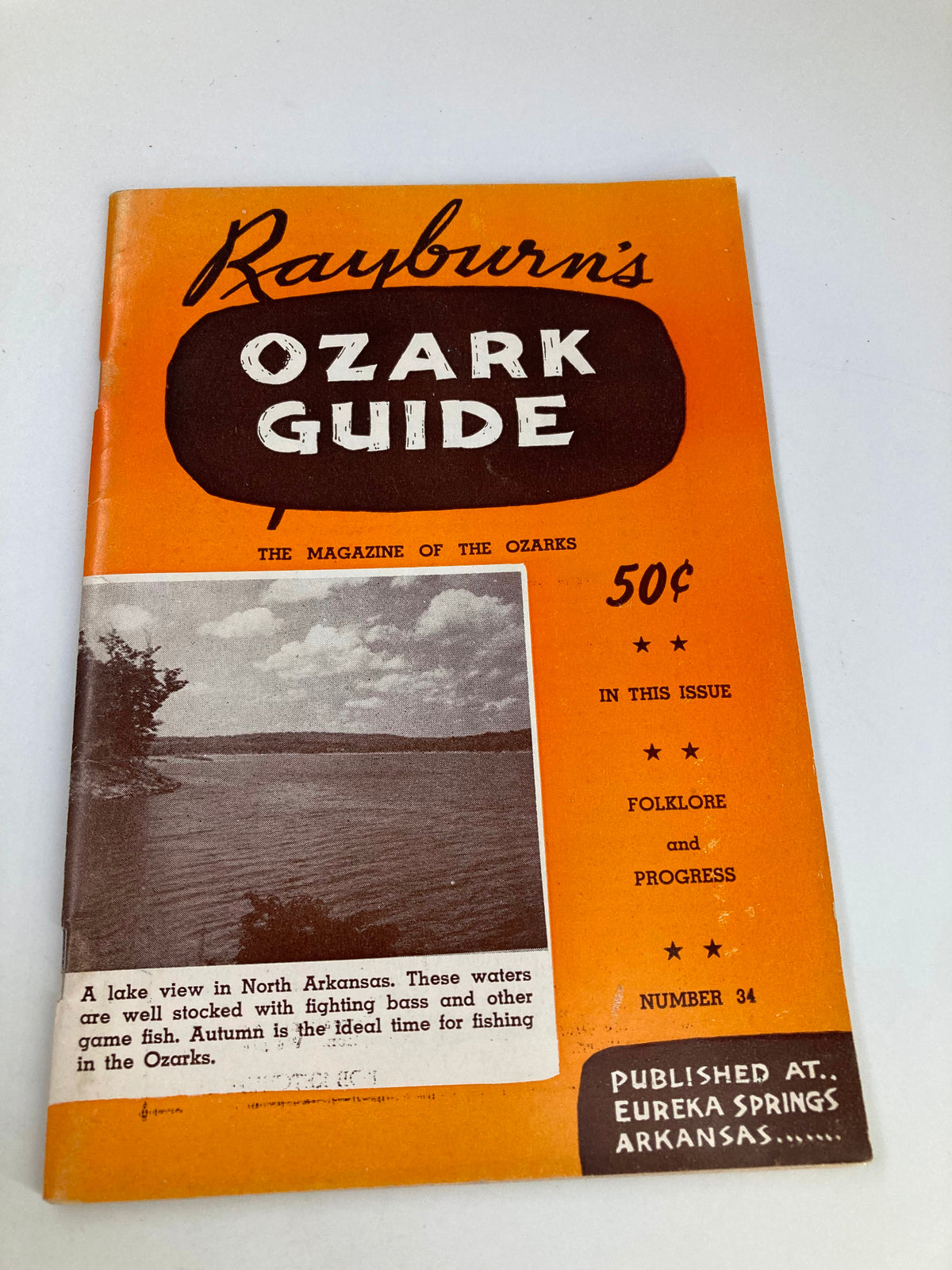Rayburn's Ozark Guide Magazine Autumn 1952 cover featuring a lake view in North Arkansas, highlighting the magazine's vintage charm with an orange design and informative text about local fishing.