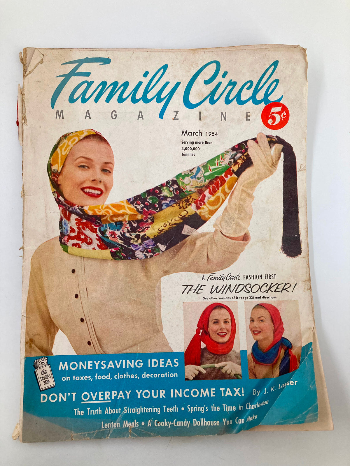 Cover of VTG Family Circle Magazine March 1954 featuring a woman in a colorful scarf, promoting money-saving ideas and tax tips.