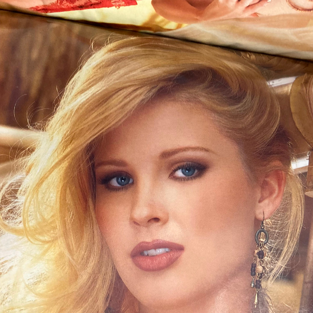 Close-up of a model's face from the Playboy Magazine September 1999 issue, showcasing alluring features and captivating blue eyes.
