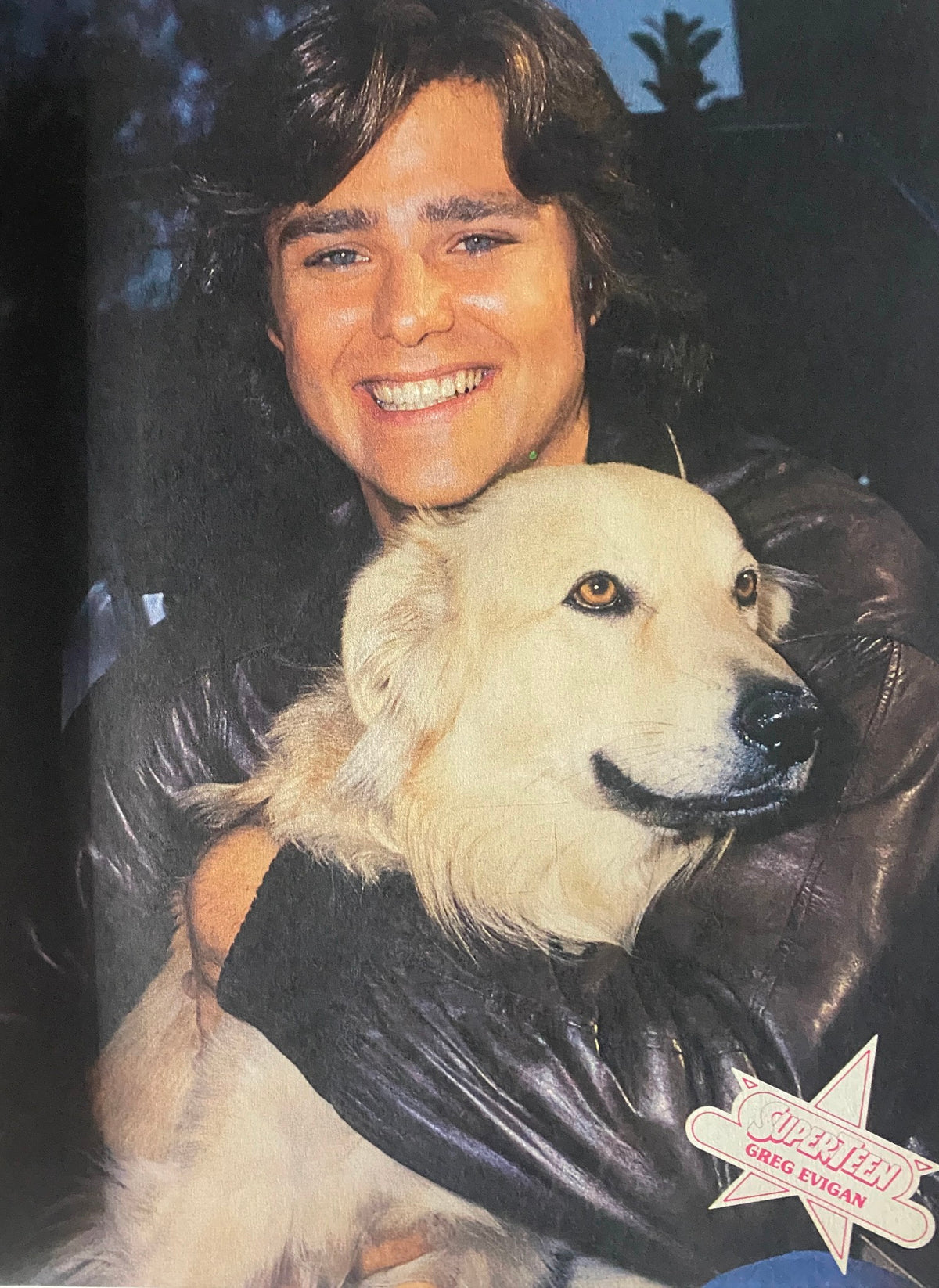 Inside image from SuperTeen Pinup Book No. 2 featuring Greg Evigan joyfully holding a dog, highlighting the nostalgic 1980s pop culture.