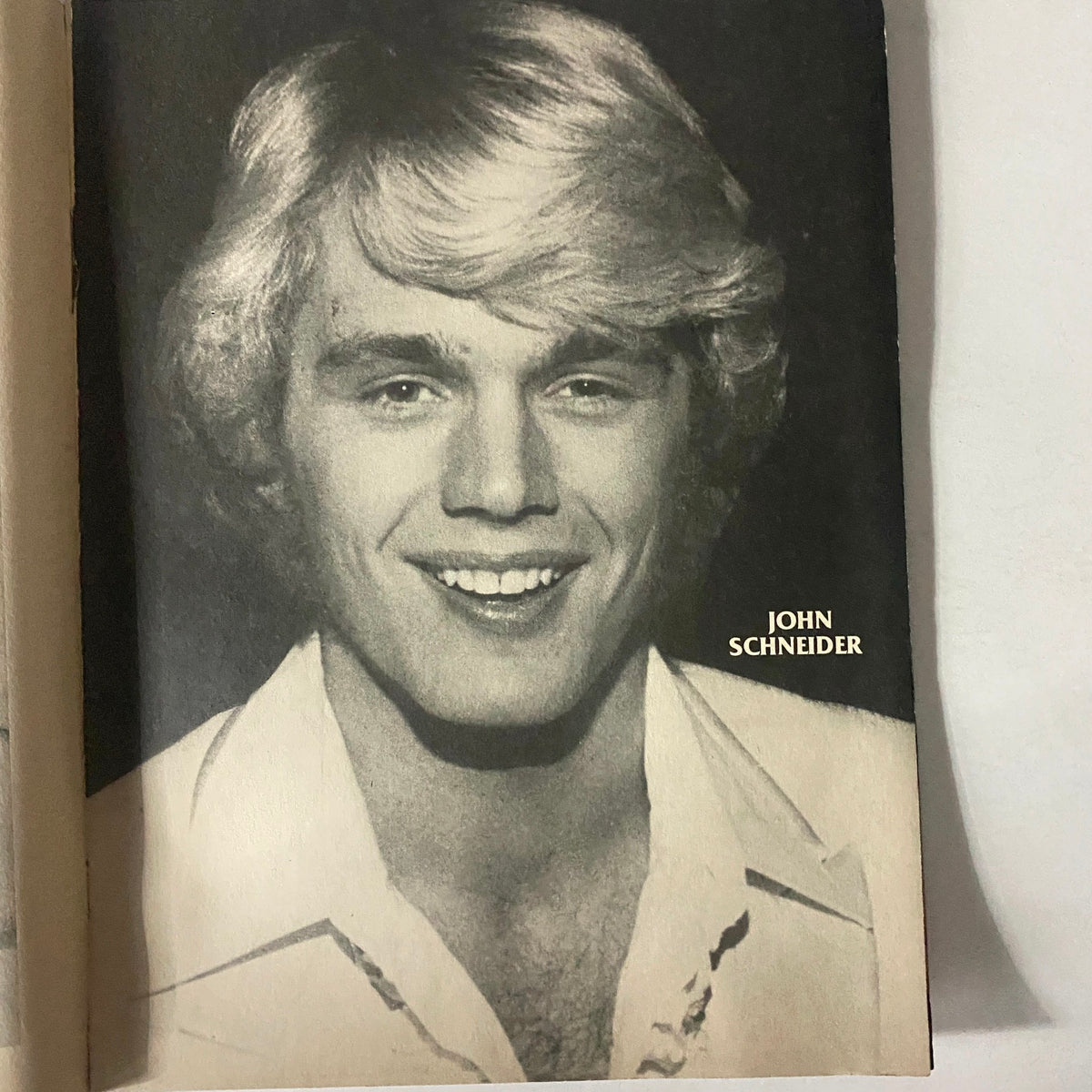 Portrait of John Schneider featured in SuperTeen Photo Album No. 5, showcasing his iconic look from the 1970s.