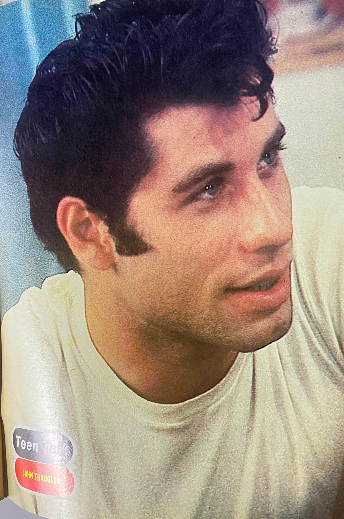 Close-up image from Teen Talk Magazine featuring a portrait of John Travolta, accompanied by the magazine's logo and a title hinting at celebrity features.