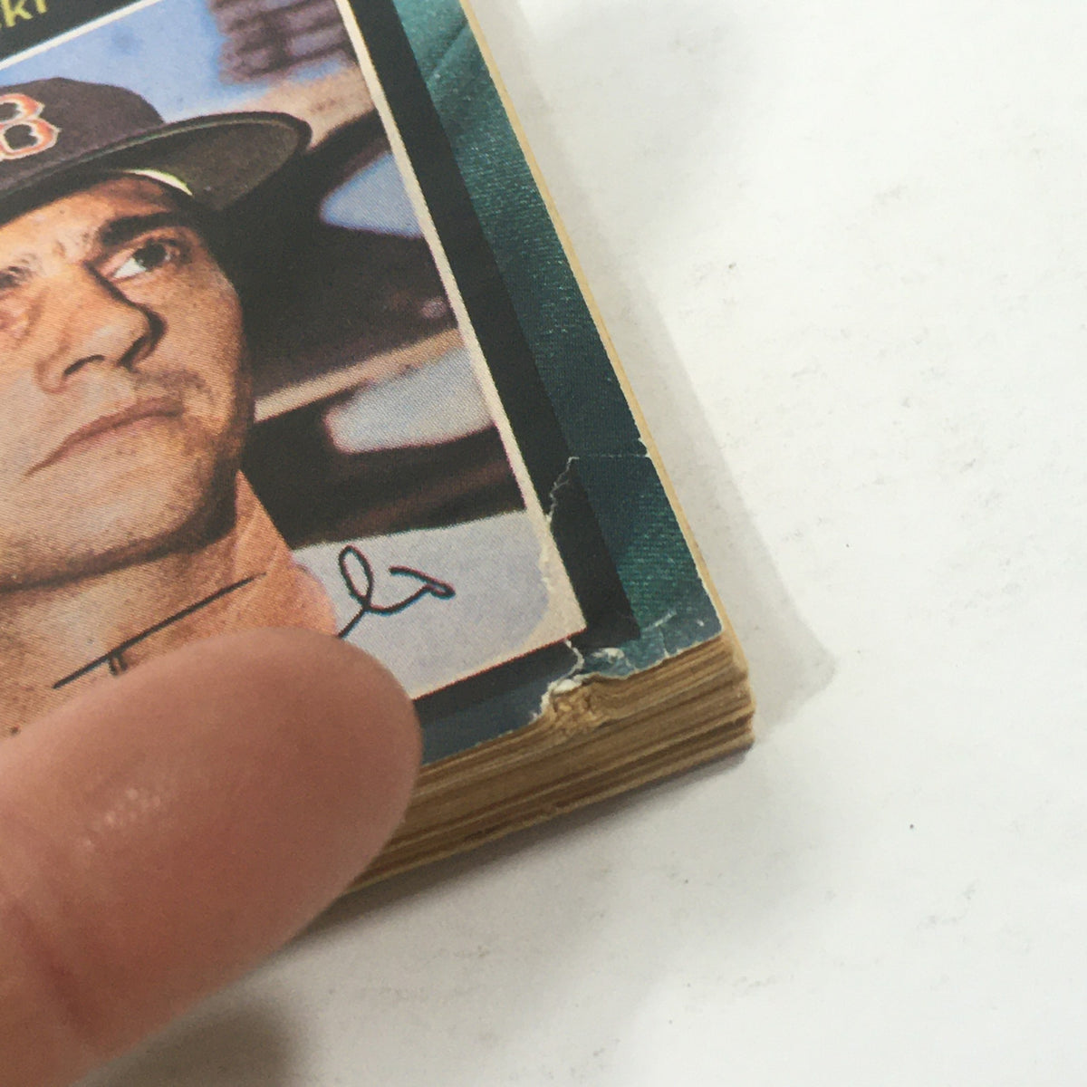 Close-up of a ripped edge on a Baseball Cards Magazine page featuring a portrait of a Boston Red Sox player, discussing condition of the item.