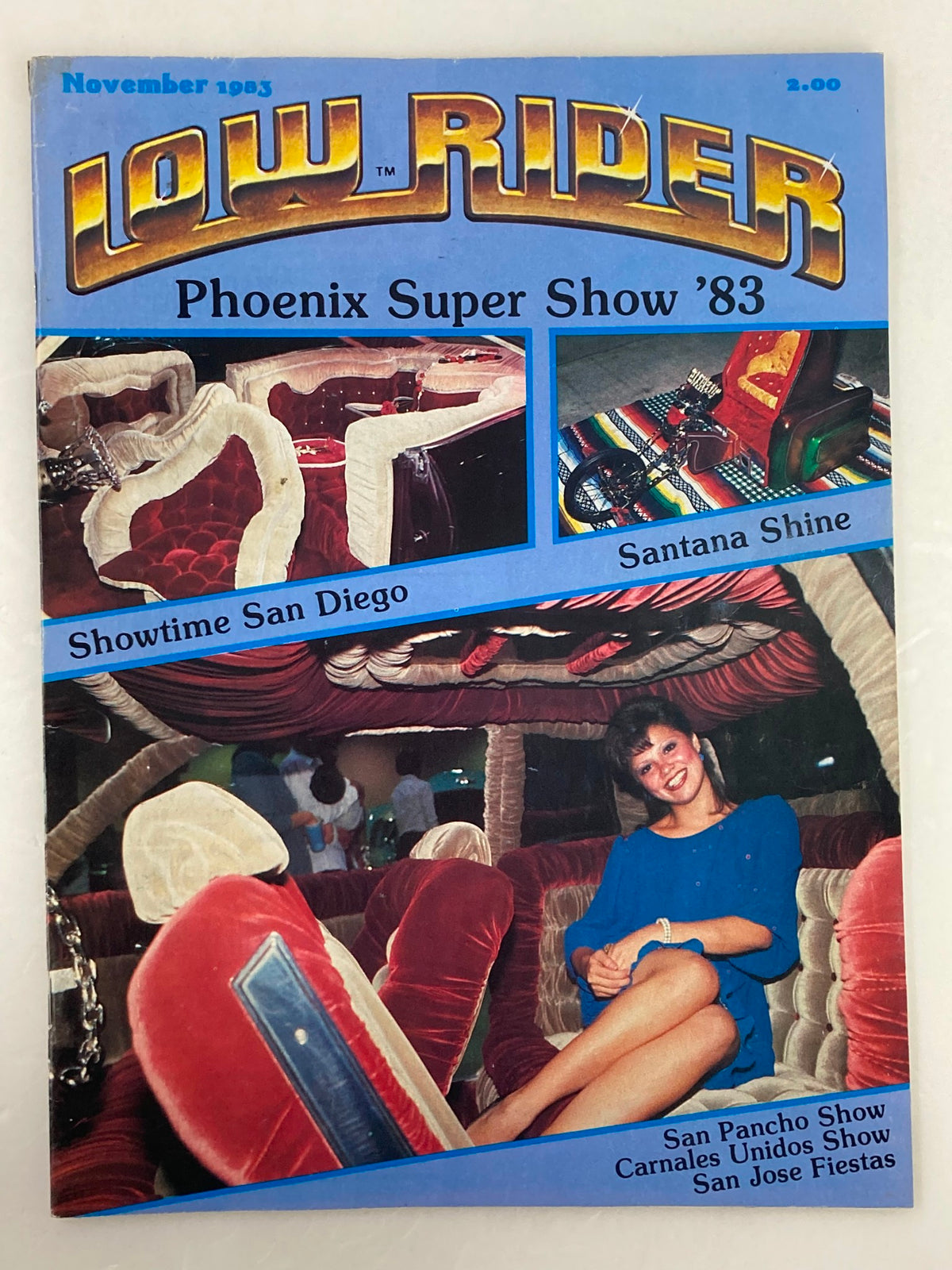 VTG LowRider Magazine November 1983 cover featuring the Phoenix Super Show '83 with images of custom car interiors and a woman posing, an iconic piece of automotive culture.