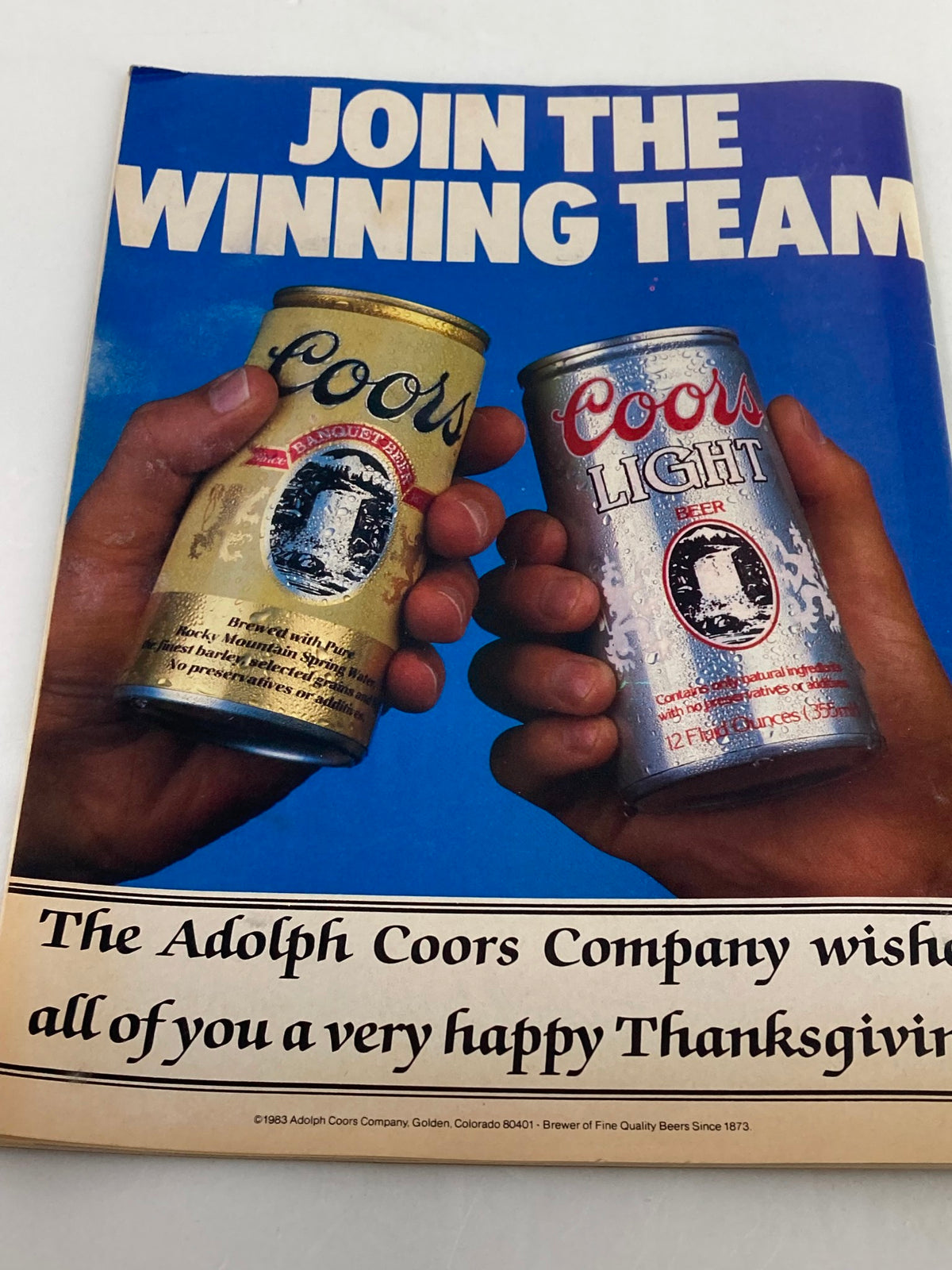 VTG LowRider Magazine November 1985 advertisement for Coors Beer, depicting two hands holding cans of Coors and Coors Light, promoting a festive Thanksgiving message.