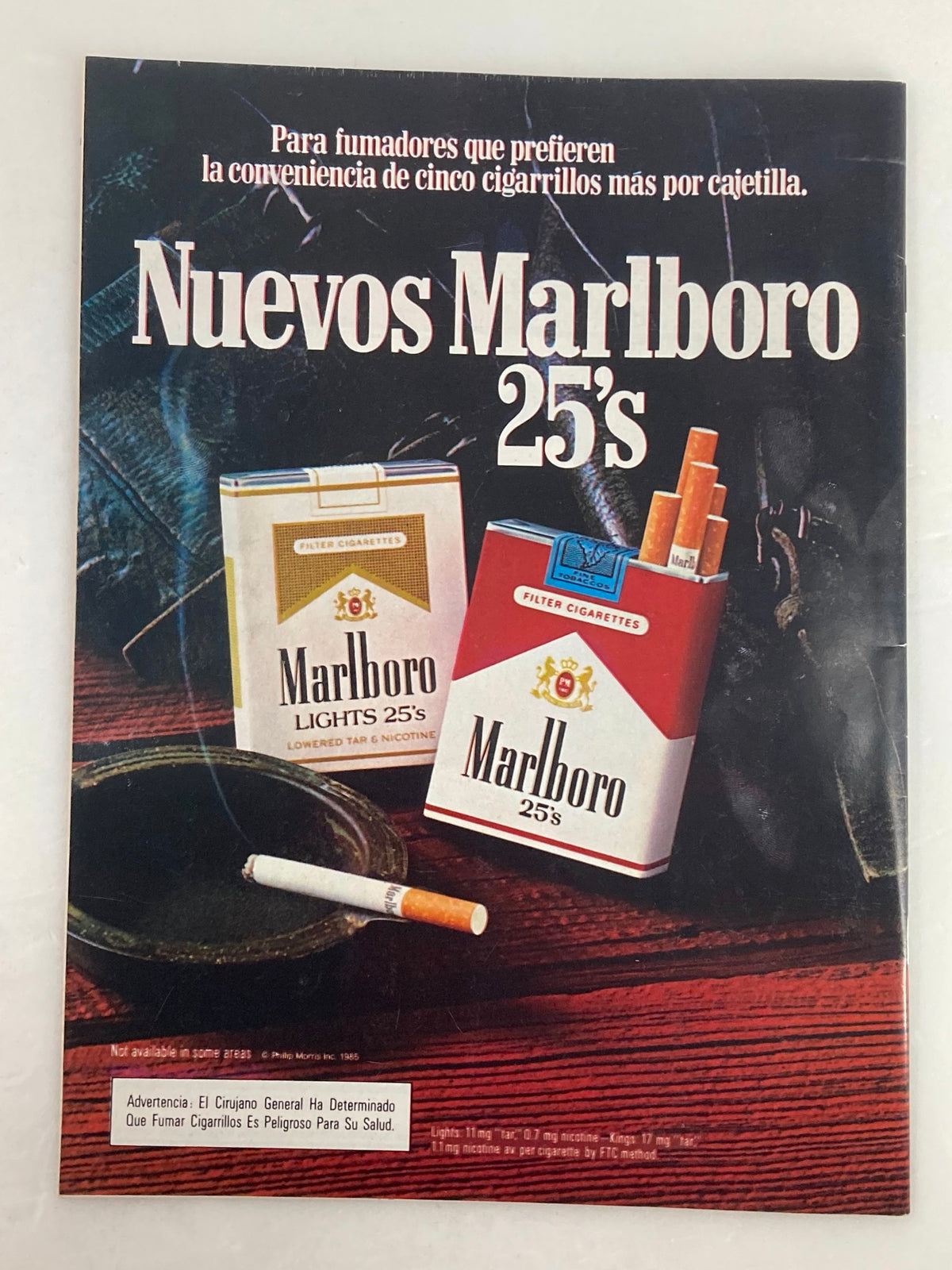 March 1985 Low Rider Magazine advertisement for Marlboro cigarettes, featuring new cigarette packs. Highlights vintage advertising styles from the 1980s.