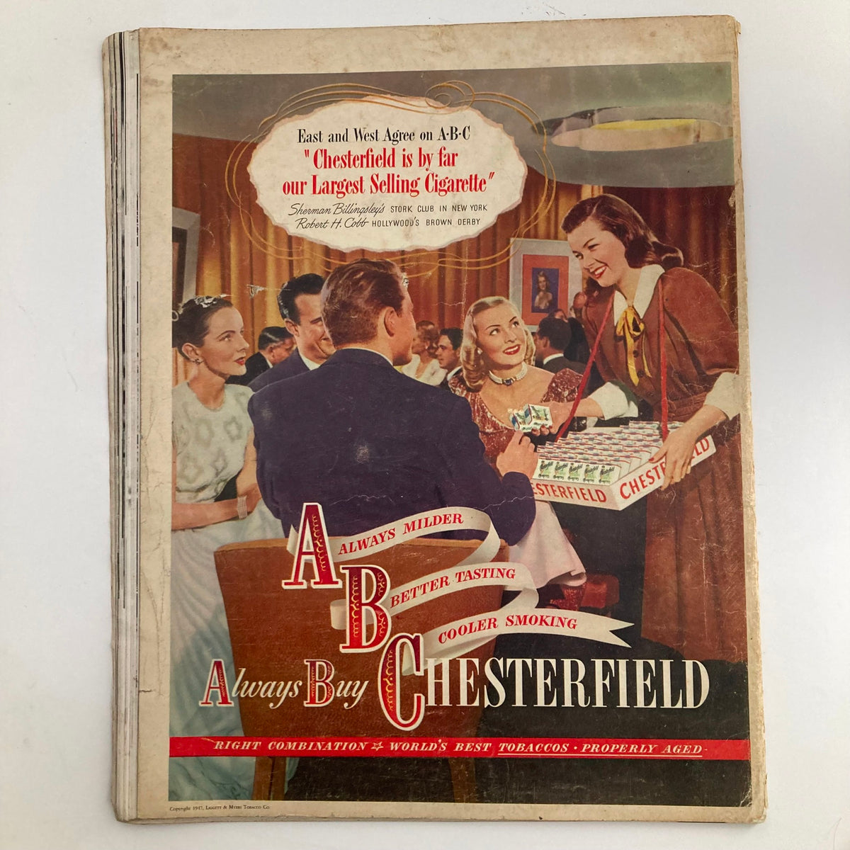 Advertisement from the back cover of VTG Look Magazine April 29 1947 promoting Chesterfield cigarettes, showcasing a social gathering with patrons enjoying the products.