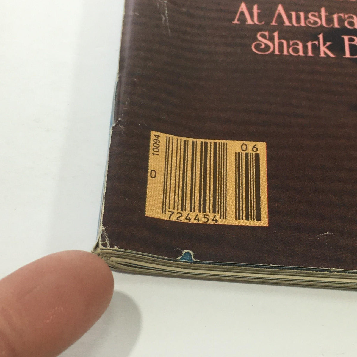 Side view of the Sports Illustrated magazine from February 11, 1985, highlighting the barcode and showing minor wear on the cover, with Paulina Porizkova's feature at Shark Bay.