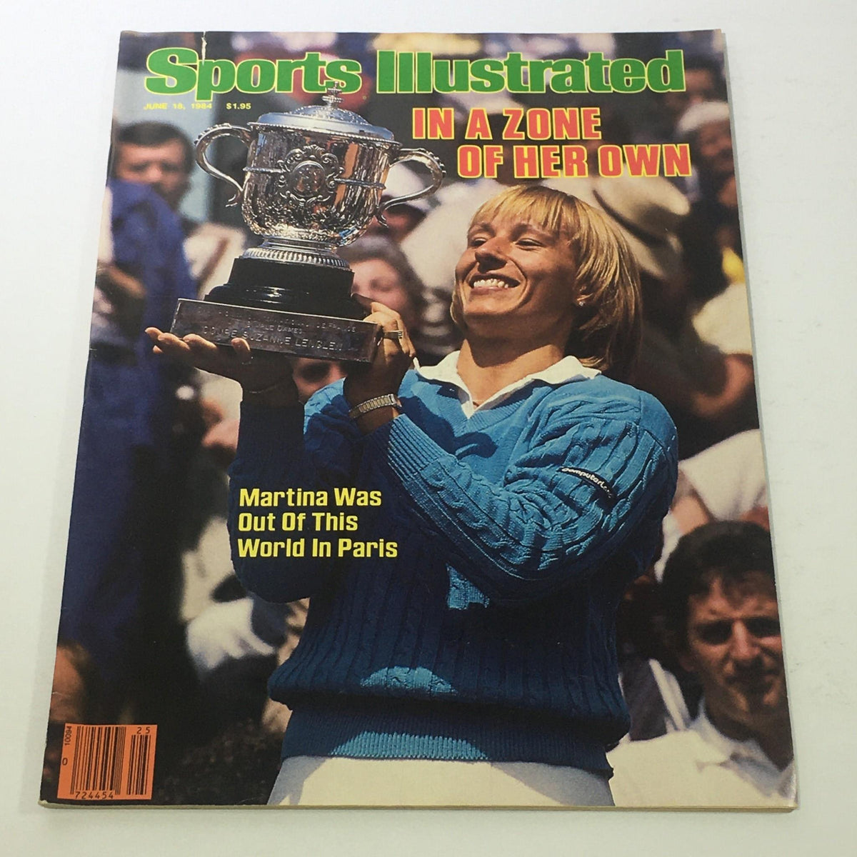 Cover of Sports Illustrated magazine from June 18, 1984, featuring the title 'In A Zone Of Her Own' with an image of Martina Navratilova holding a trophy, celebrating her achievements in tennis.