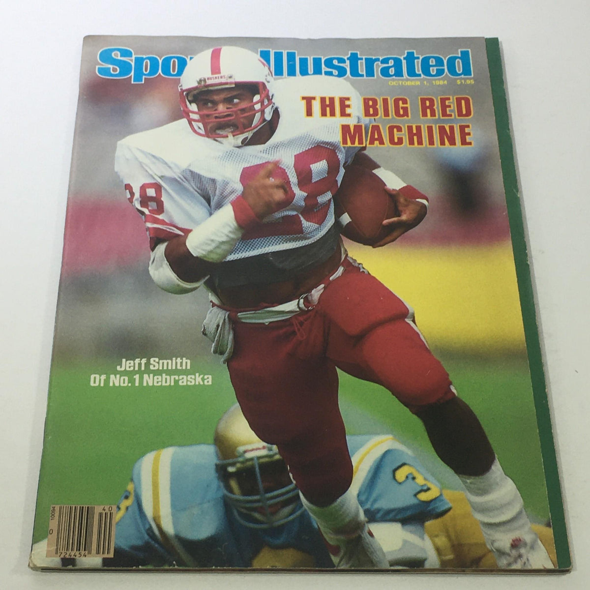 Cover of Sports Illustrated from October 1, 1984, featuring NFL player Jeff Smith wearing jersey number 28, representing Nebraska's football team, with the title 'The Big Red Machine' prominently displayed.