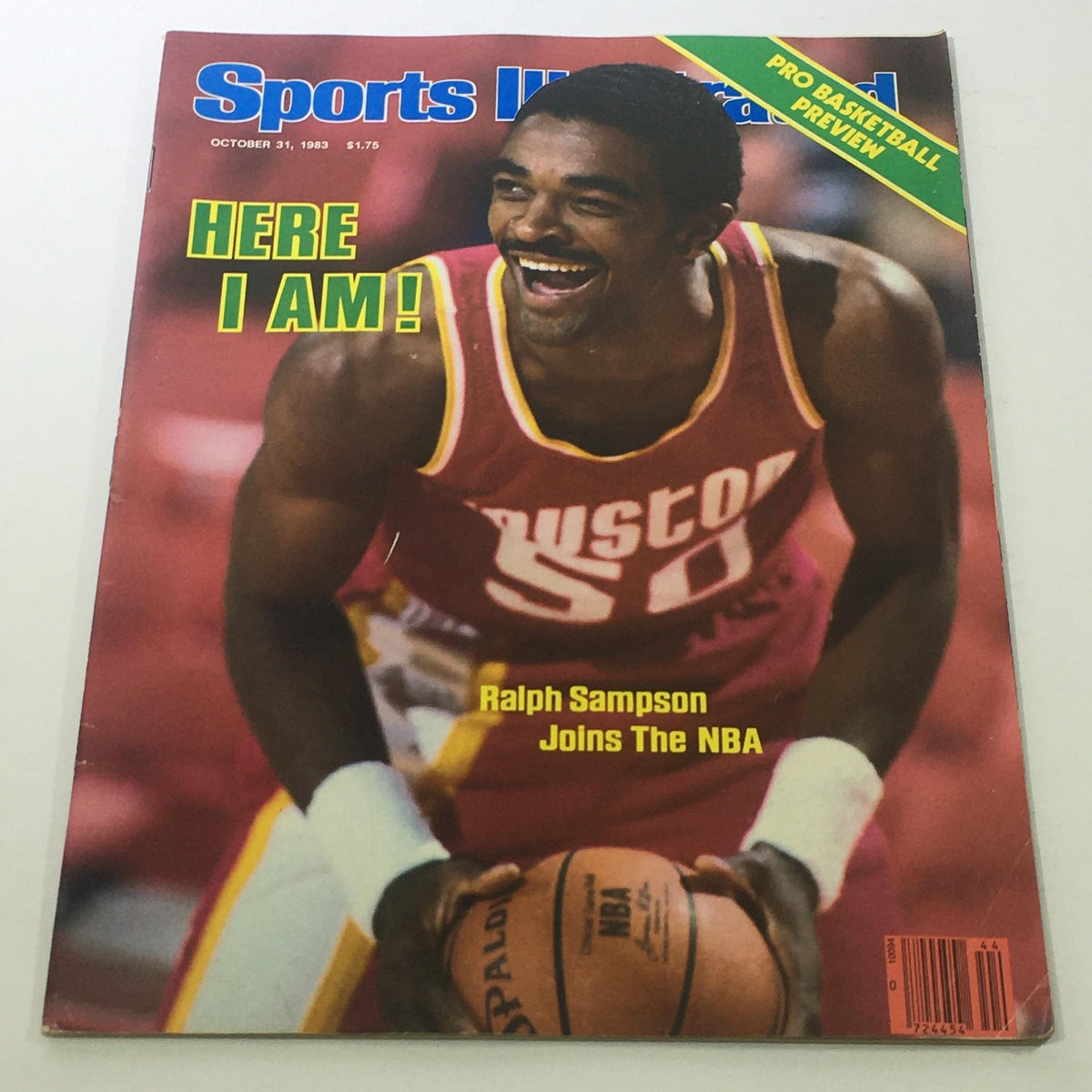Sports Illustrated cover from October 31, 1983 featuring Ralph Sampson, celebrating his entry into the NBA with the caption 'HERE I AM!' and showcasing his joyful expression while holding a basketball.