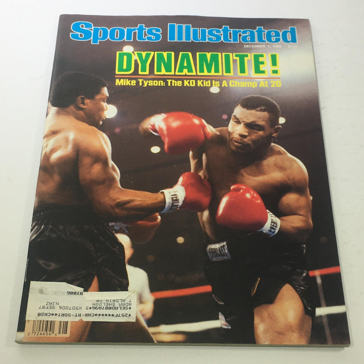 Sports Illustrated December 1, 1986 issue featuring Mike Tyson, known as 'The KO Kid,' illustrated on the cover with an action shot of him boxing, showcasing his power and athleticism at the young age of 20. The cover highlights the theme 'Dynamite!' reflecting Tyson's explosive boxing style.