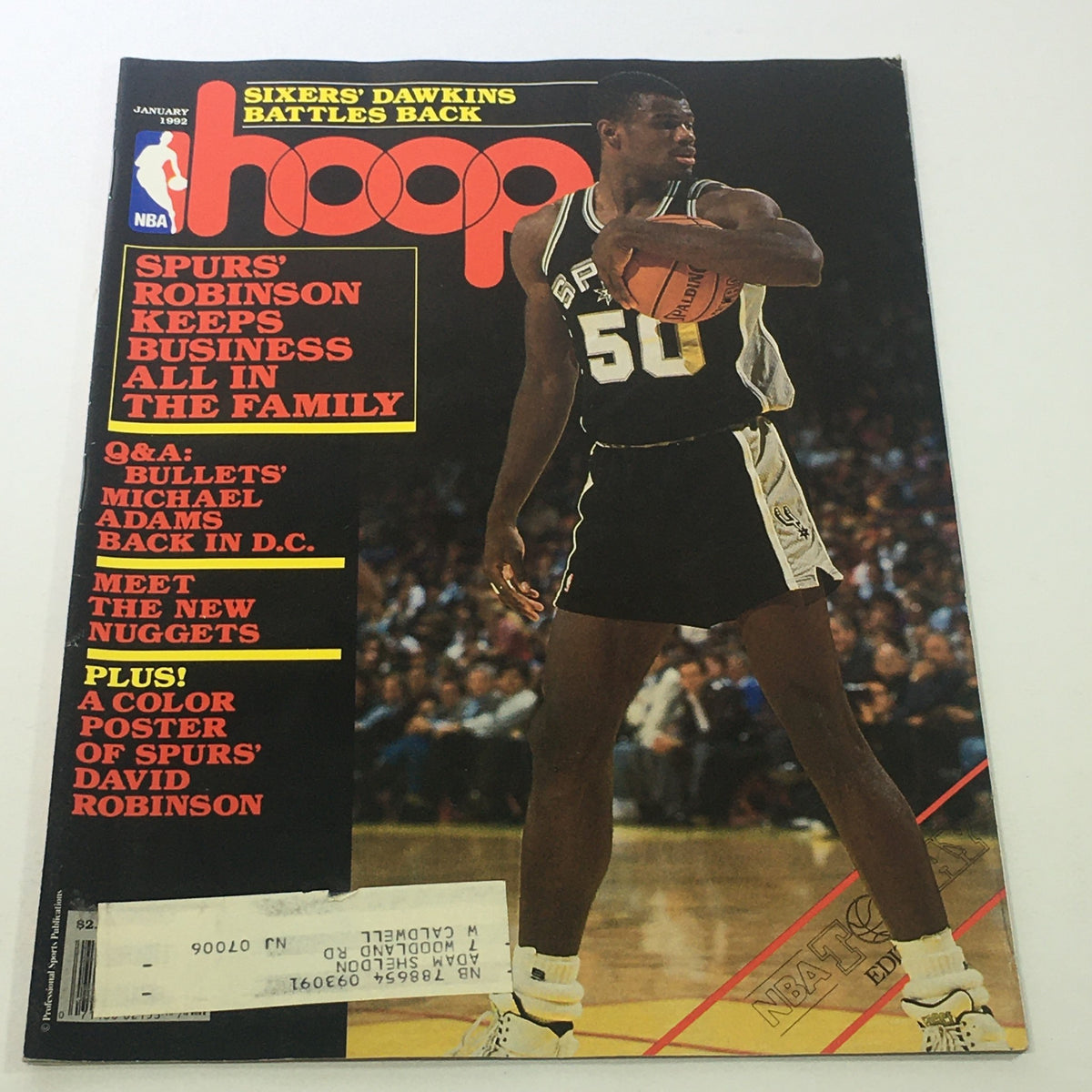 Hoop NBA Magazine cover from January 1992 featuring David Robinson on the front, showcasing the headline ‘Spurs' Robinson Keeps Business All in the Family’. The image highlights Robinson in action while wearing a San Antonio Spurs uniform, capturing the essence of 90s basketball culture.