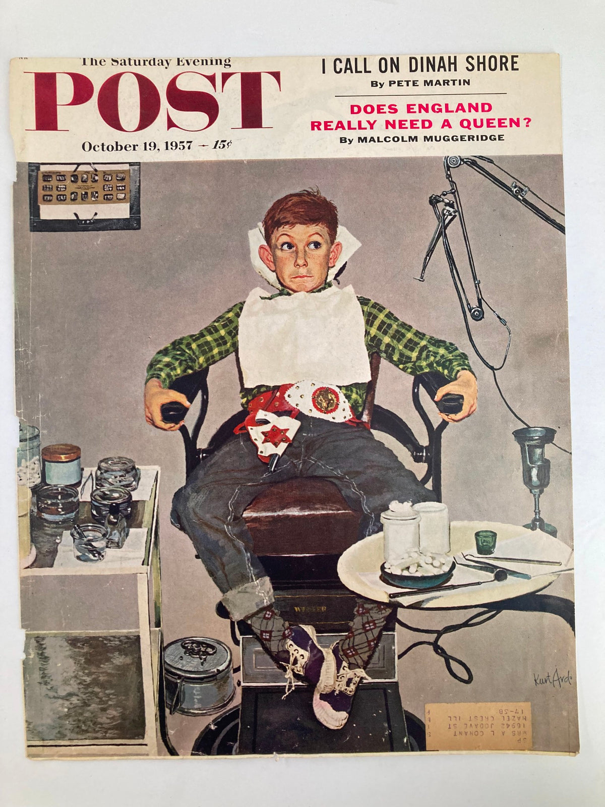 Cover of The Saturday Evening Post dated October 19, 1957, depicting a boy seated in a barber's chair, looking surprised while wearing a bib, surrounded by barbering equipment. Title: I Call On Dinah Shore.