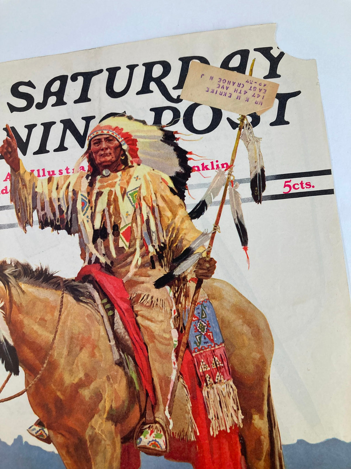Close-up view of The Saturday Evening Post cover from August 22, 1936, highlighting a Native American figure on horseback, dressed in traditional attire, holding a spear and a sign. The cover presents the title 'Two Against The Arctic' and the subtitle 'Dear Mother: I'm in Jail!' by Honoré Morrow.