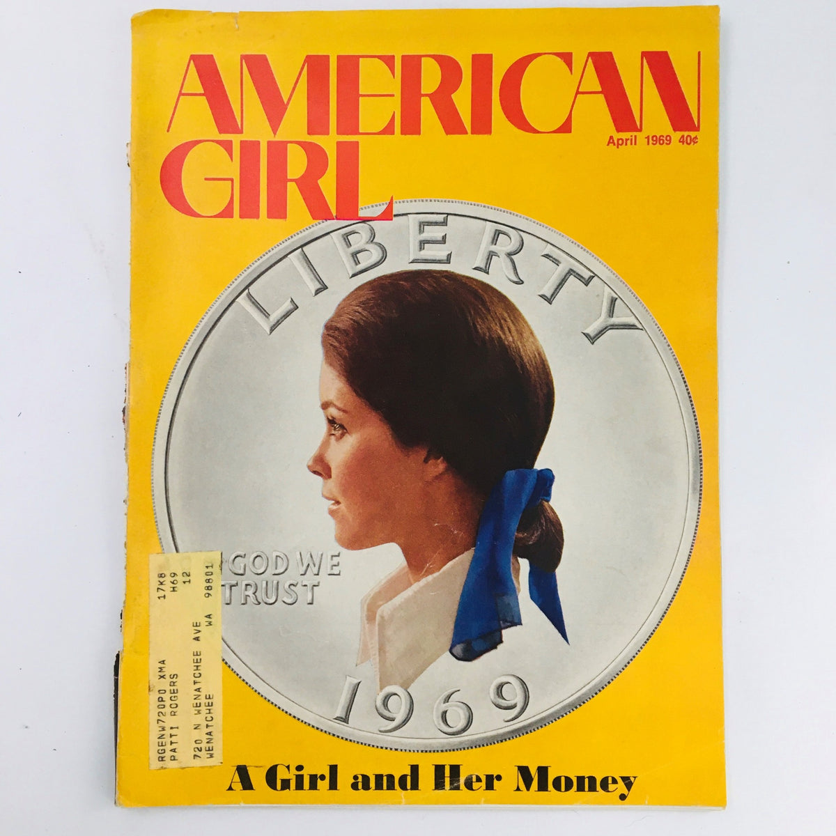 Cover of American Girl Magazine April 1969 featuring the article 'A Girl and Her Money' and a Liberty coin, emphasizing financial literacy for young girls.