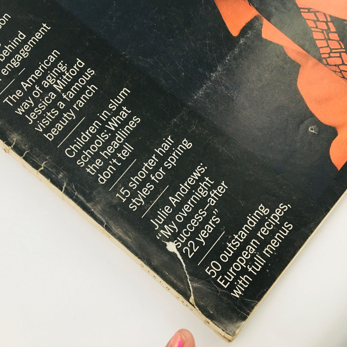 Detailed view of the McCall's Magazine March 1966 cover showing featured article titles including 'Children in slum schools' and '15 shorter hair styles for spring'.