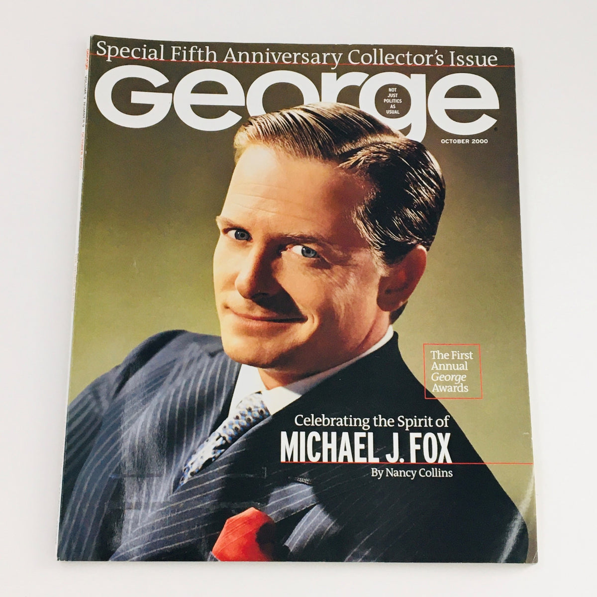 George Magazine October 2000 cover celebrating the spirit of Michael J. Fox by Nancy Collins, featuring a portrait of Michael J. Fox in a stylish suit.