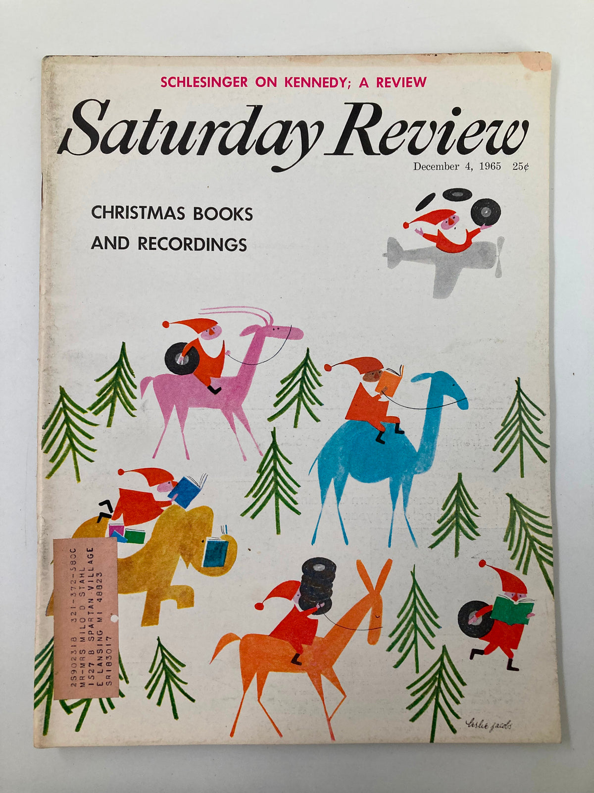 Vintage Saturday Review Magazine from December 4, 1965 featuring a colorful cover illustration of Santa Claus riding camels and other animals, promoting Christmas books and recordings.