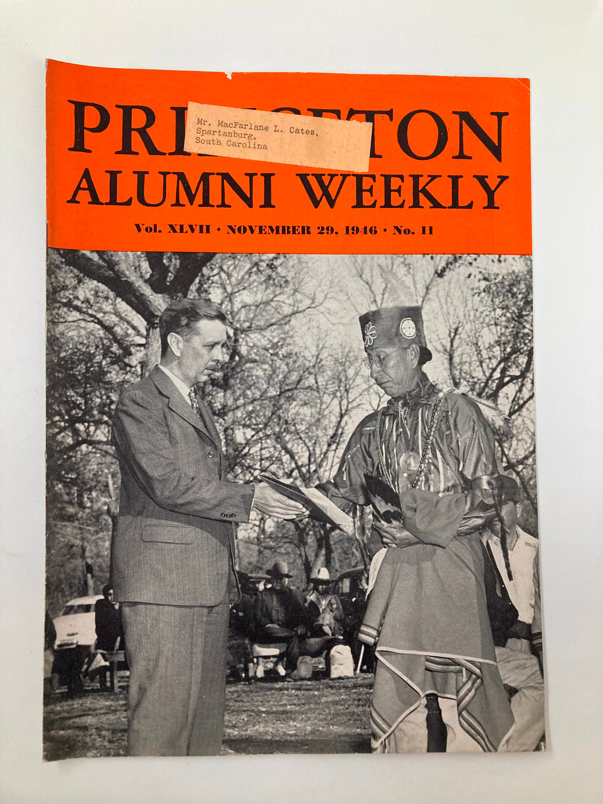 Cover of VTG Princeton Alumni Weekly from November 29, 1946, featuring a ceremonial scene with a man in a suit and an individual dressed in traditional attire, capturing a moment in Princeton's history.