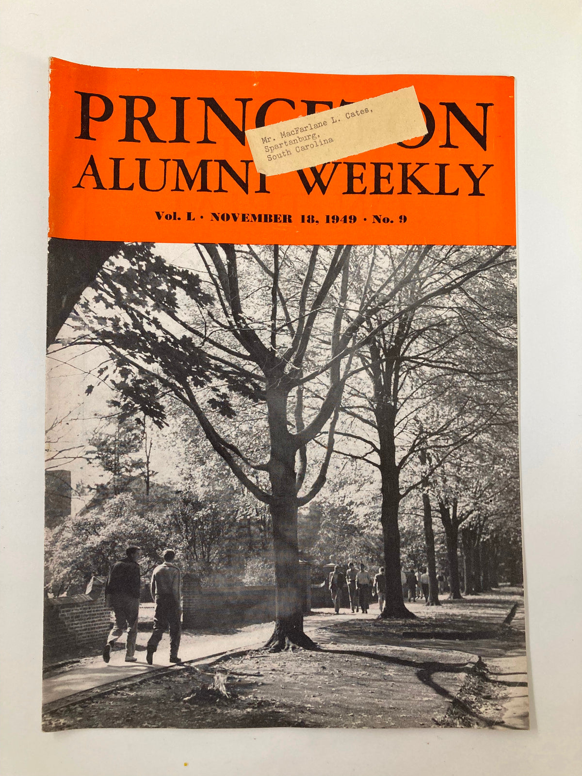 Cover of the VTG Princeton Alumni Weekly dated November 18, 1949, featuring an orange header and a historical black and white photograph of individuals walking along a tree-lined path.