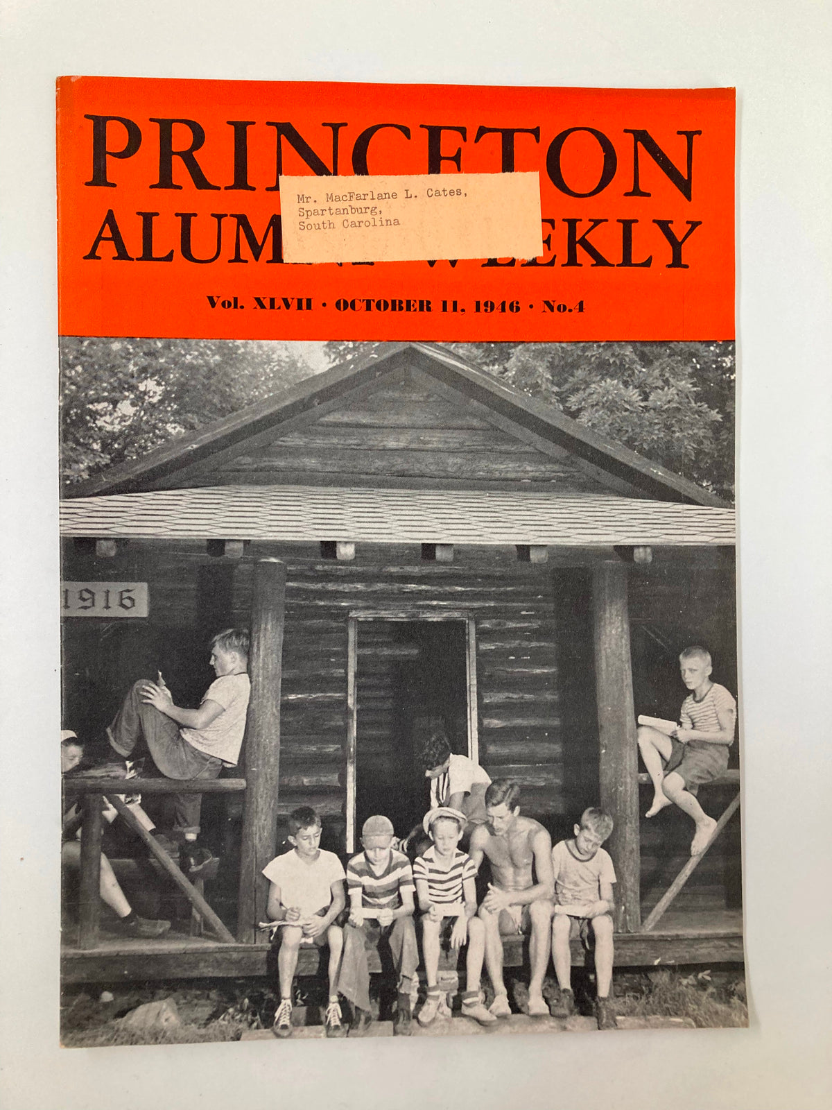 Cover of VTG Princeton Alumni Weekly from October 11, 1946, featuring children sitting on a log cabin porch with a label attached, commemorating the Special Charter Day Ceremony.