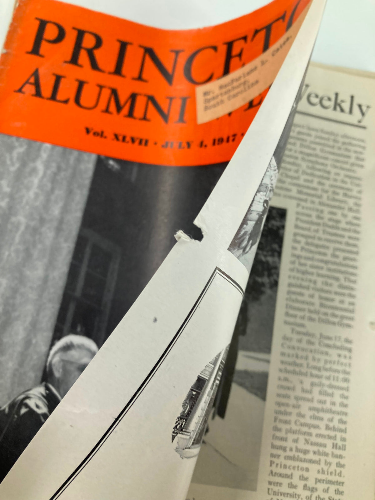 Close-up of the damaged cover of VTG Princeton Alumni Weekly July 4, 1947, showing a tear and handwritten label.