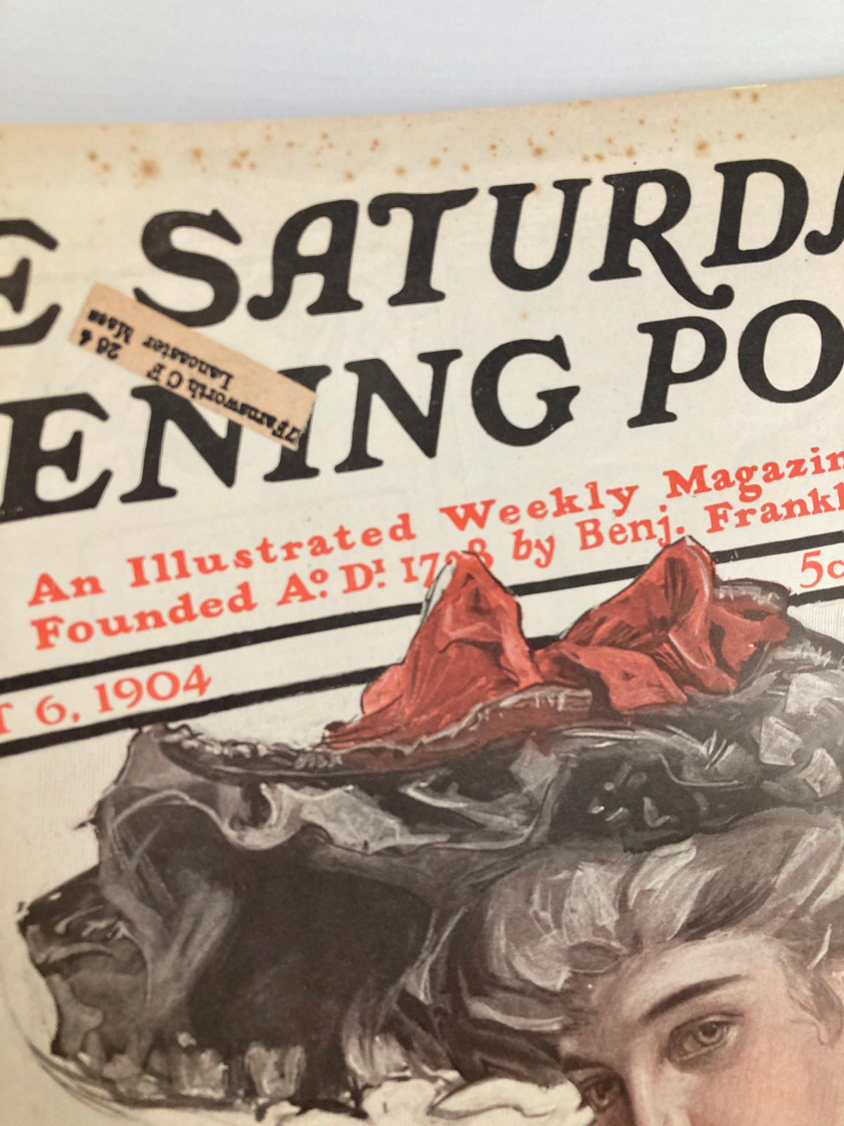 Close-up view of The Saturday Evening Post cover dated August 6, 1904, highlighting the title 'Beginning The Eagle's Shadow', featuring vintage design elements and a woman's portrait.