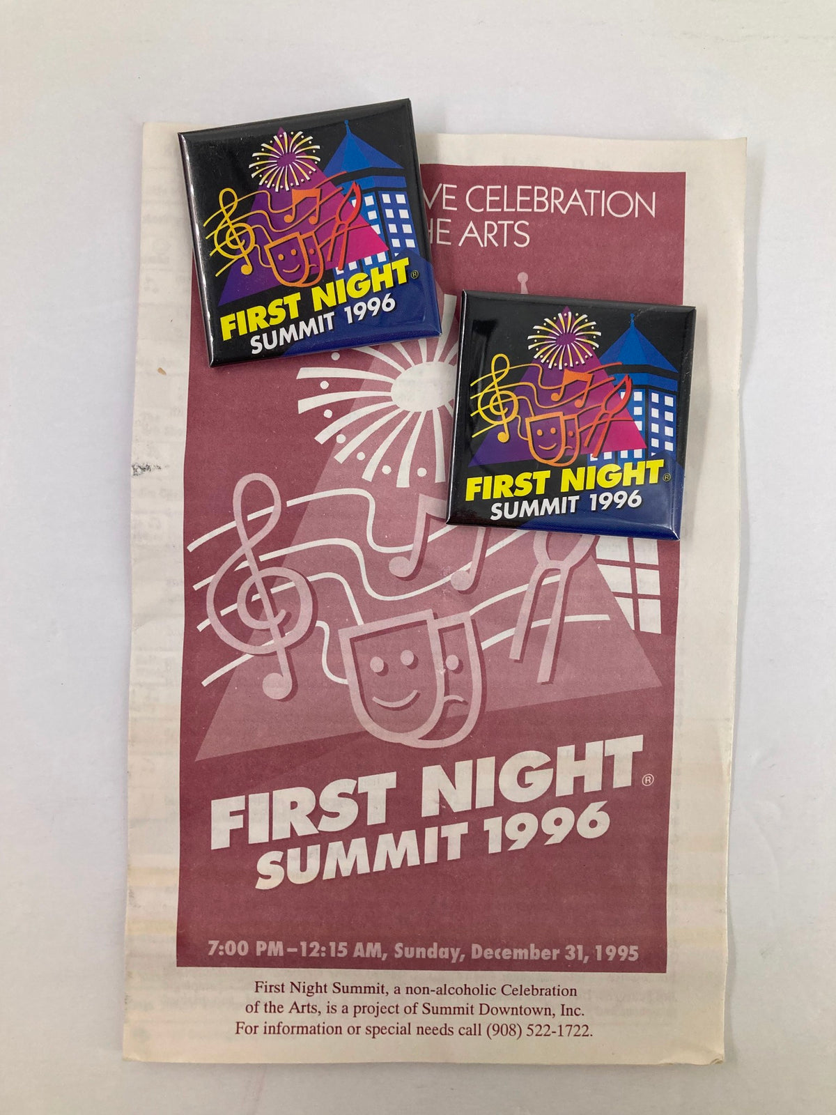 1996 Program First Night Summit A Non-Alcoholic Celebration featuring the event schedule and two commemorative pins. The image shows the program with vibrant graphics and musical notes, highlighting a festive atmosphere.