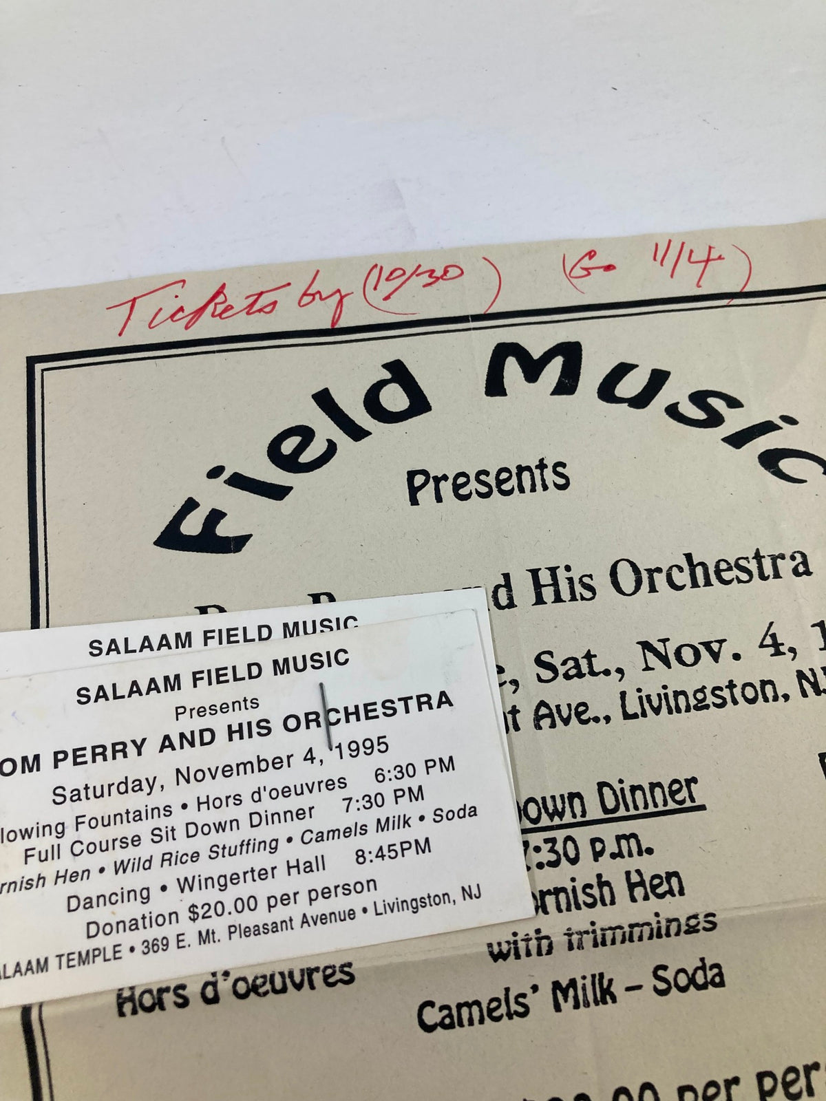 1995 Program Salaam Field Music Presents Dom Perry and His Orchestra - close-up of the ticket attached to the program, including handwritten notes and event details.