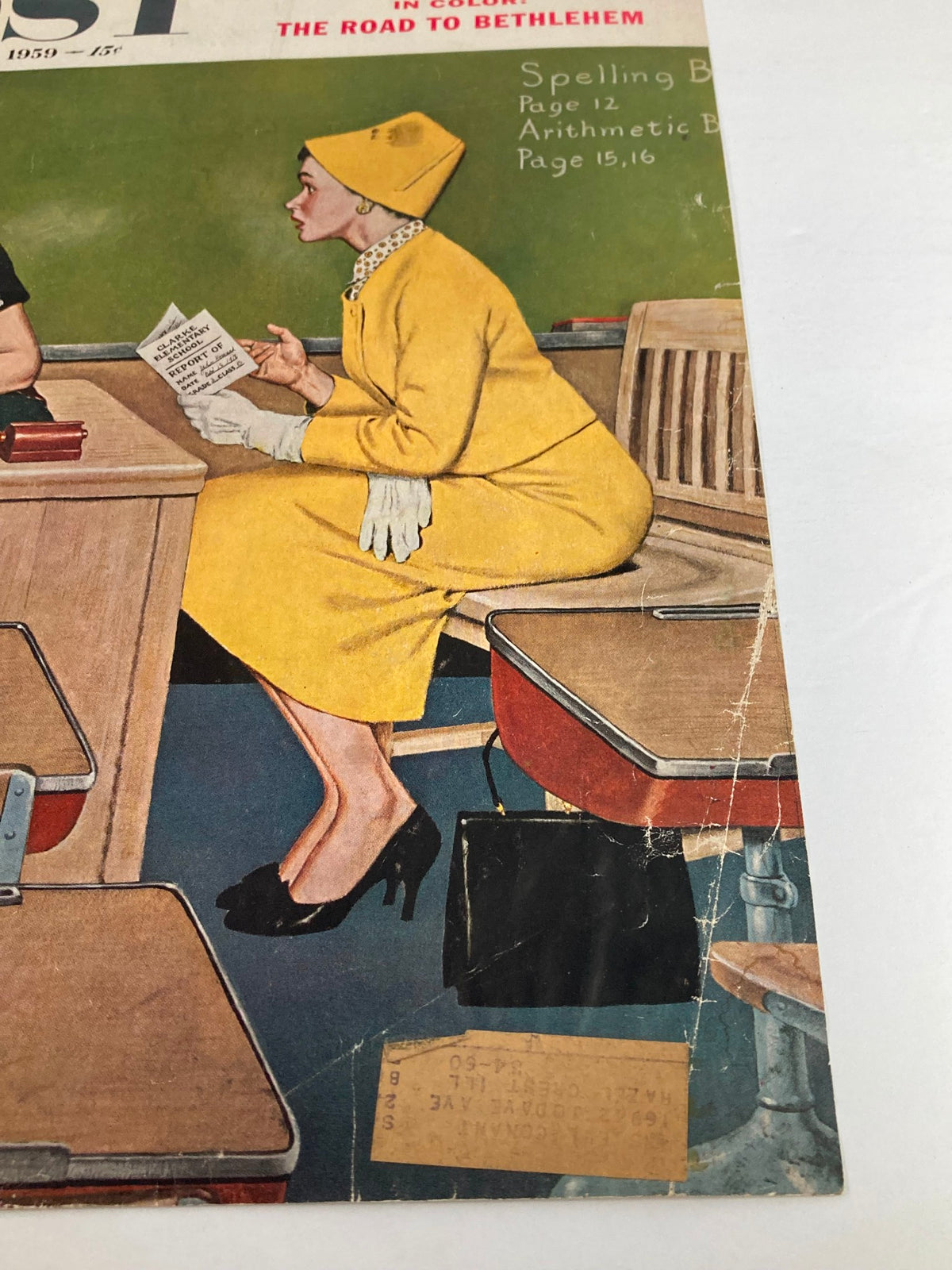 COVER ONLY The Saturday Evening Post December 12 1959 featuring a woman in a yellow coat and hat, sitting at a desk and reading a report in a classroom setting, highlighting vintage fashion of the late 1950s.