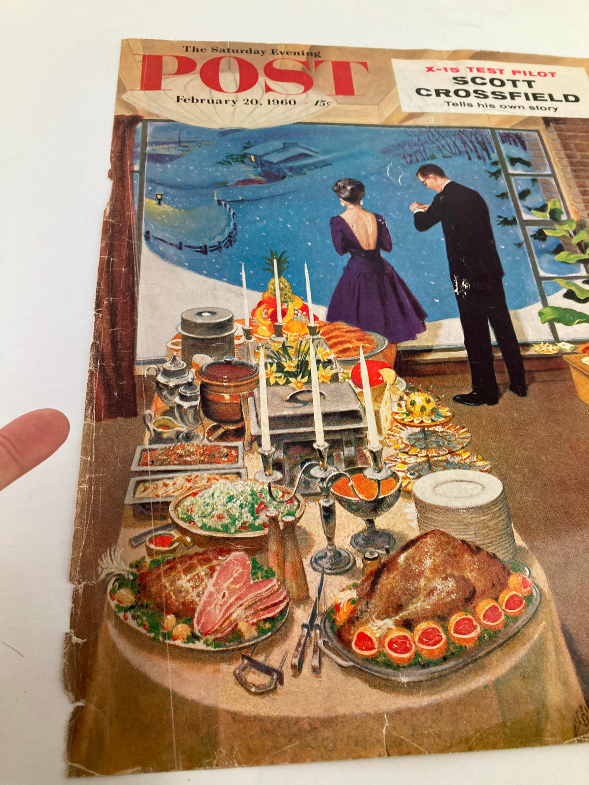 Detailed view of The Saturday Evening Post cover from February 20, 1960, featuring Scott Crossfield; highlights vintage dining arrangements and a couple looking out at a winter landscape.