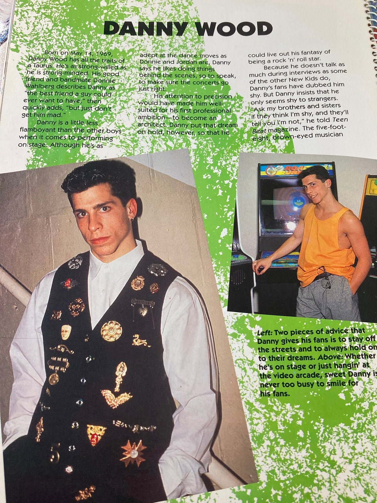 1990 Publications International, Ltd. Presents New Kids On The Block - A portrait of Danny Wood wearing a vest adorned with pins, reflecting his stylish persona.
