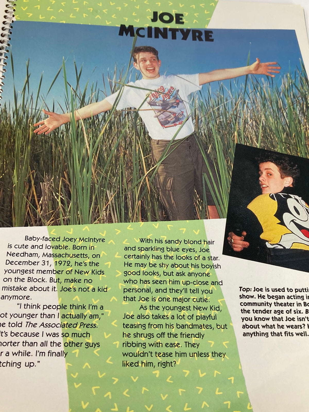 1990 Publications International, Ltd. Presents New Kids On The Block - Joe McIntyre smiling with arms outstretched in a natural setting, capturing his playful character.