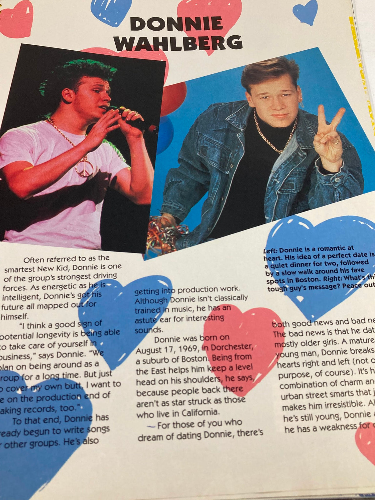 1990 Publications International, Ltd. Presents New Kids On The Block - Donnie Wahlberg performing on stage, showcasing his energetic presence and fashion sense.