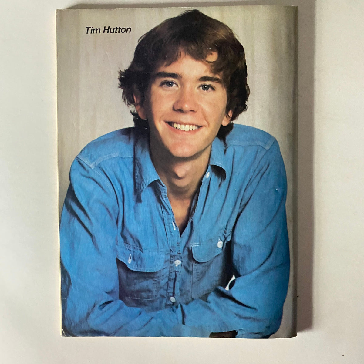 Tim Hutton smiling with a casual blue shirt, featured in Tiger Beat Magazine, April 1981, capturing the youthful charm of 1980s Hollywood.