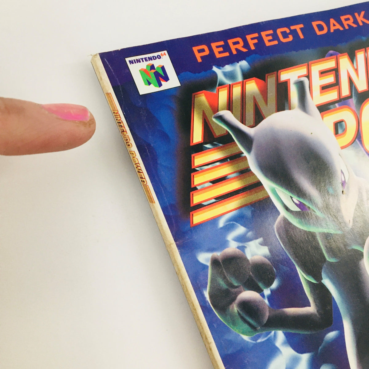 Side view of Nintendo Power Magazine March 2000 Vol 130 with a focus on the edge and logo, capturing the nostalgia of vintage gaming.