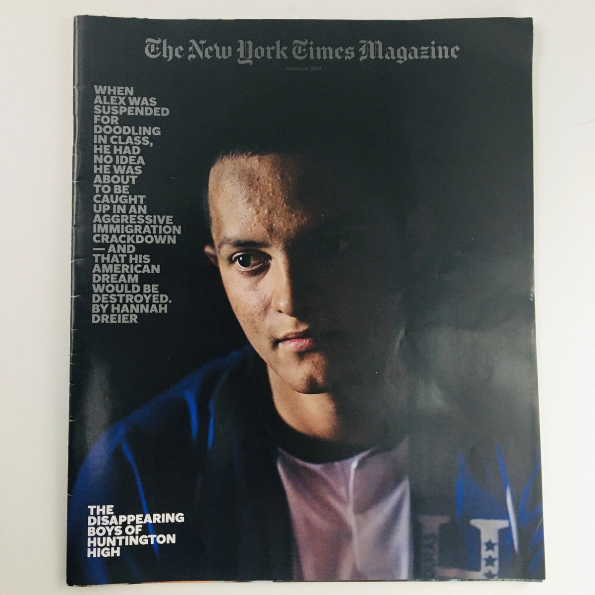 Cover of The New York Times Magazine January 6, 2019, featuring the headline 'The Disappearing Boys of Huntington High' along with an image of a young man reflecting the themes of immigration and education.