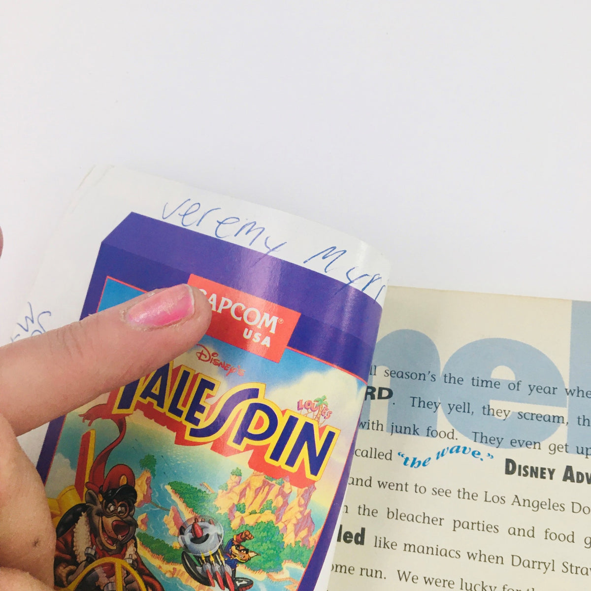 Interior page of Disney Adventures The Magazine July 1992 showcasing a hand pointing to a Talespin game advertisement, reflecting the era's entertainment and media.