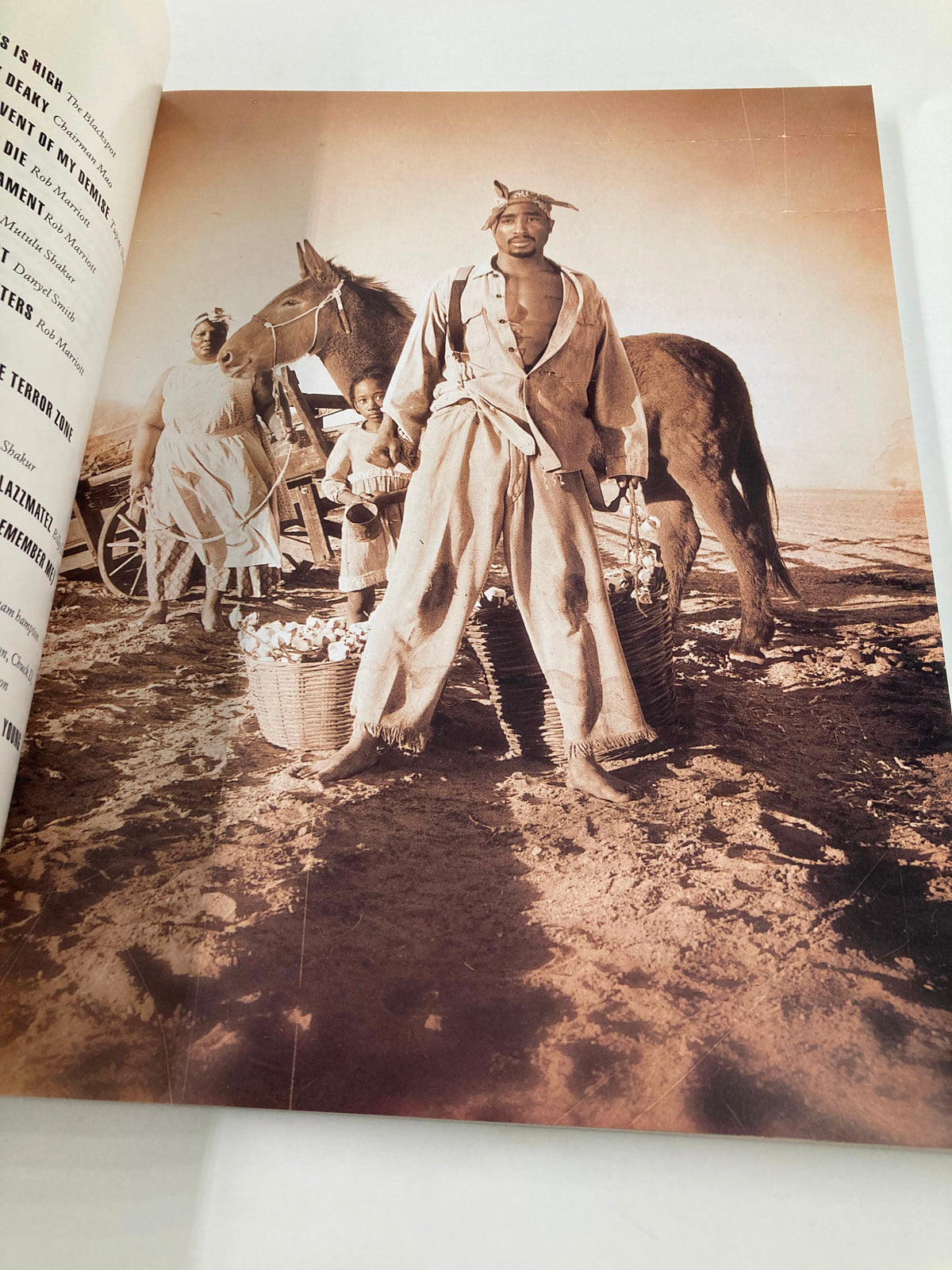 Historical photo of a man with horse and baskets, from 'The New York Times Best Seller Memoir of Tupac Shakur 1971 - 1996', illustrating the roots and background that shaped Tupac's identity.