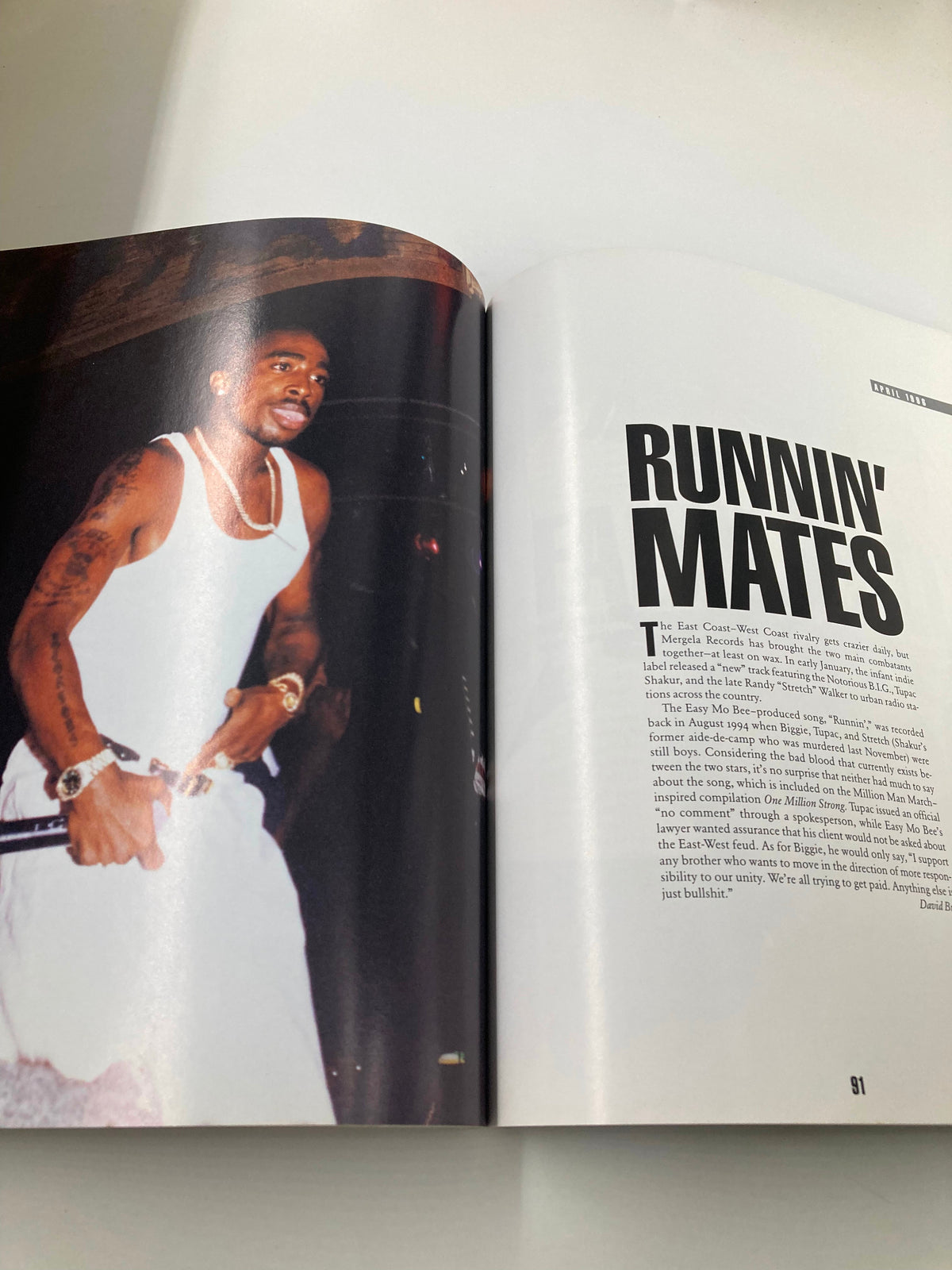 Tupac Shakur Memoir - A dynamic performance shot of Tupac Shakur on stage, showcasing his energetic presence in hip-hop.