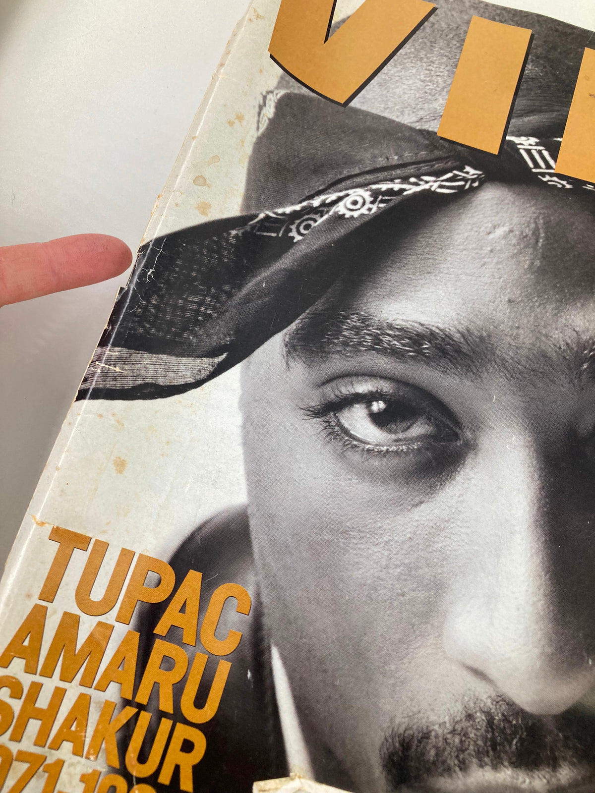 Close-up of Vibe Magazine November 1996 featuring Tupac Amaru Shakur, showcasing the magazine cover with visible wear and details, celebrating the life of the iconic rapper.