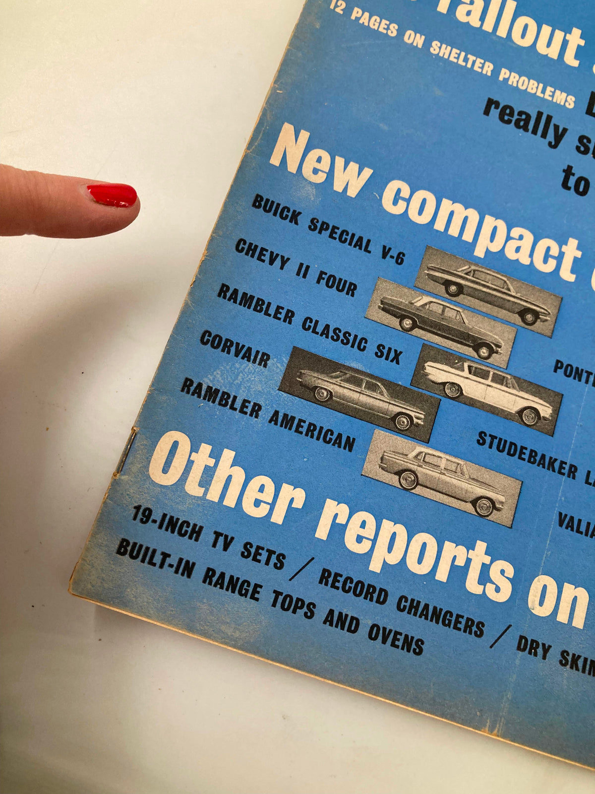 New cover design of the January 1962 issue of Consumer Reports Magazine featuring a blue background with car models listed, illustrating the theme of 'The Fallout Shelter' as described in the title 'VTG Consumer Reports Magazine January 1962 The Fallout Shelter No Label'.
